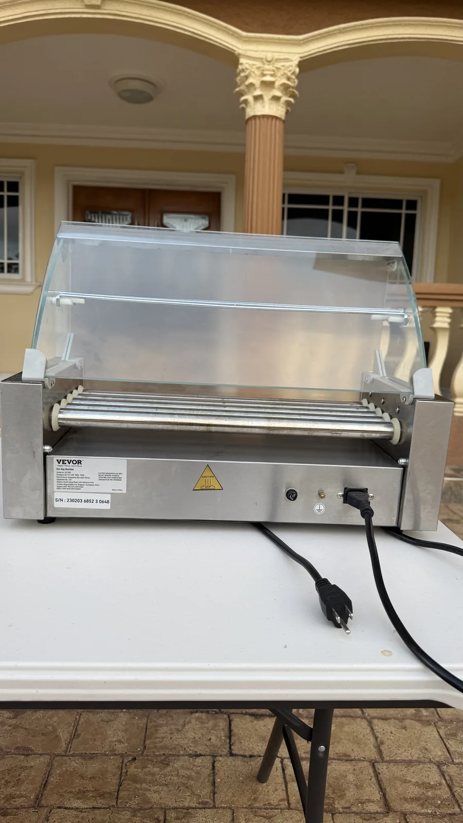 Rear view of the hot-dog grill showing its power connection