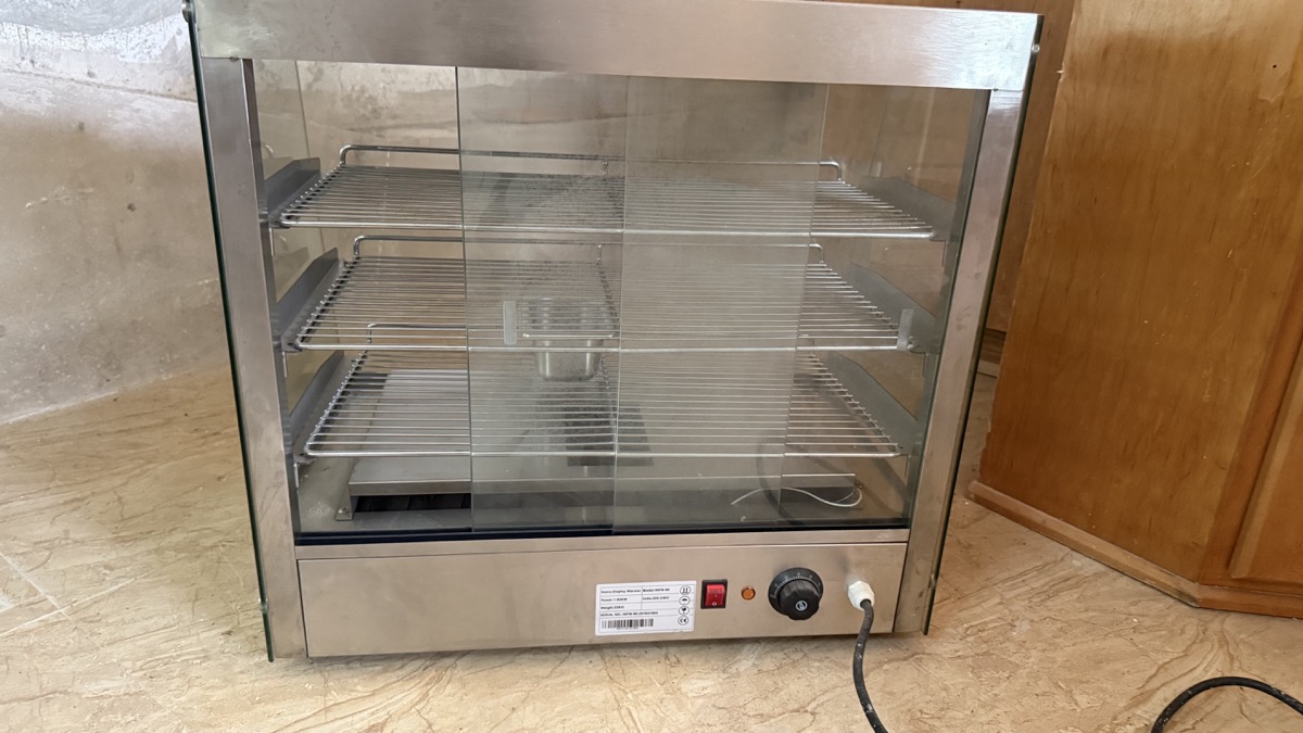Front view of the Infernus INFW-60 heated patty display warmer with three shelves
