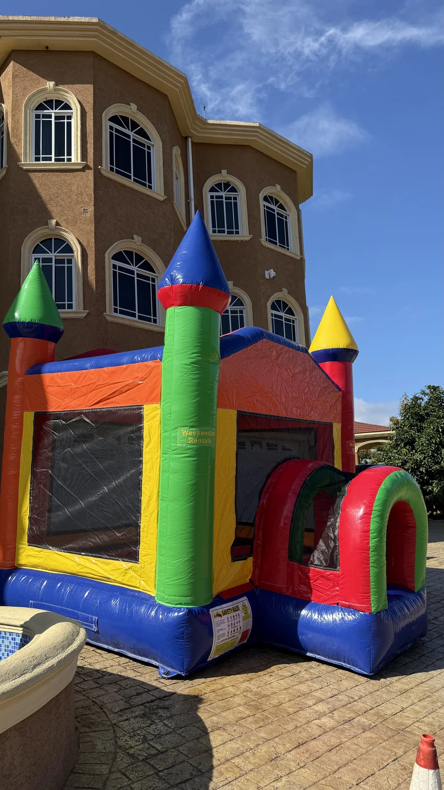 Three-quarter view of the colourful 12 by 12 foot castle bouncer