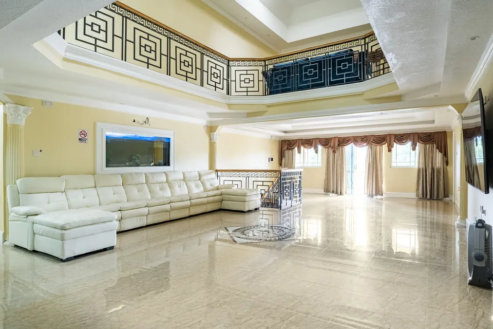The main living area on the first floor. This consists of a spacious couch with a built in fish tank and an 85" Samsung Smart tv.