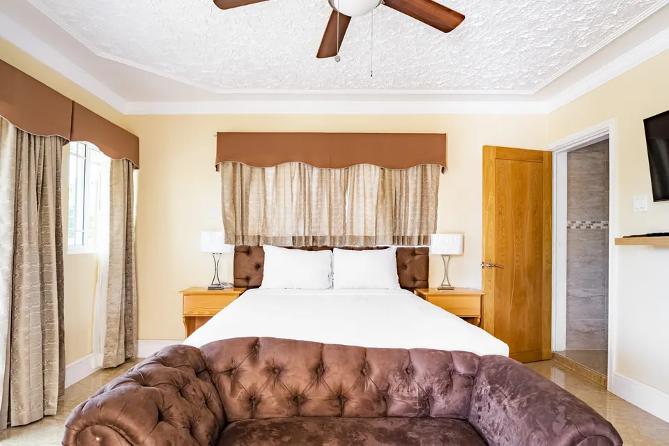 Room 0 ( First room of two on the ground floor). This room consists of an AC unit, a ceiling fan, a 42" Samsung Smart tv, a patio, an en suite bathroom as well as a private entrance.