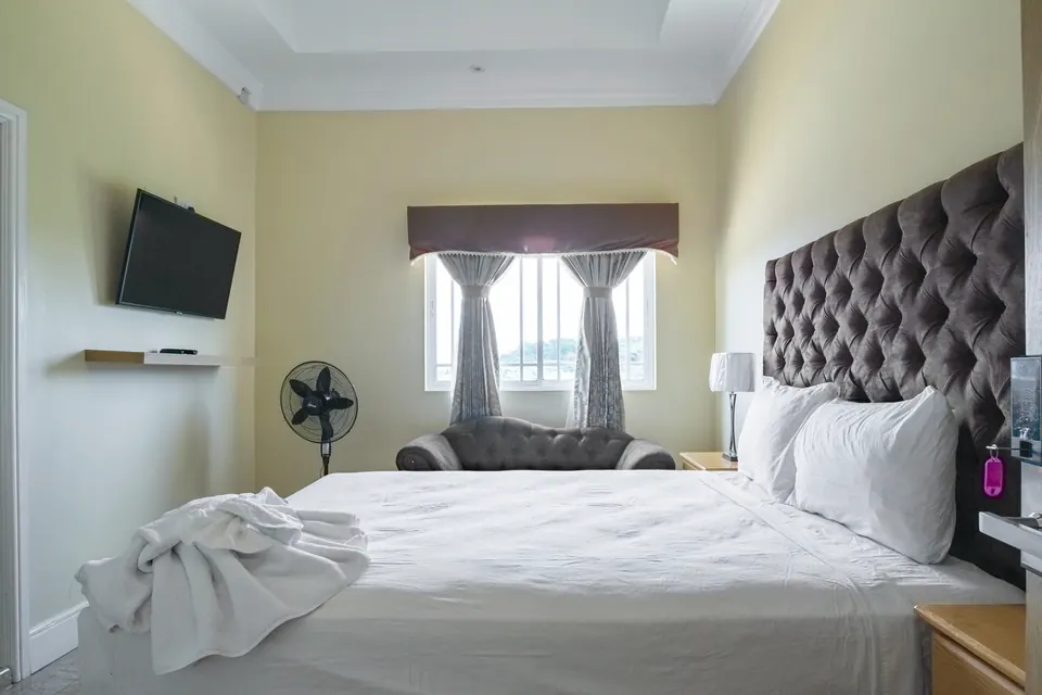 Room 10 ( fifth of the five rooms on the second floor). This room consists of an AC unit, a standing fan, a 42" Samsung Smart tv, as well as an en suite bathroom.