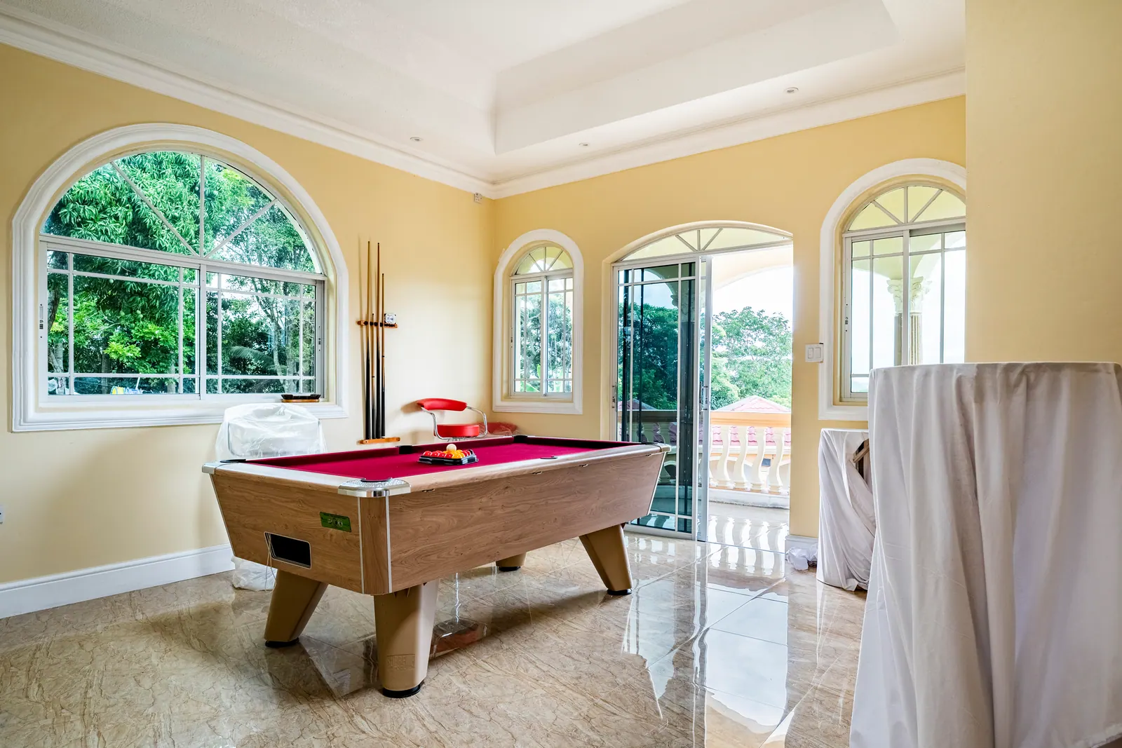 Bright games room with a pool table