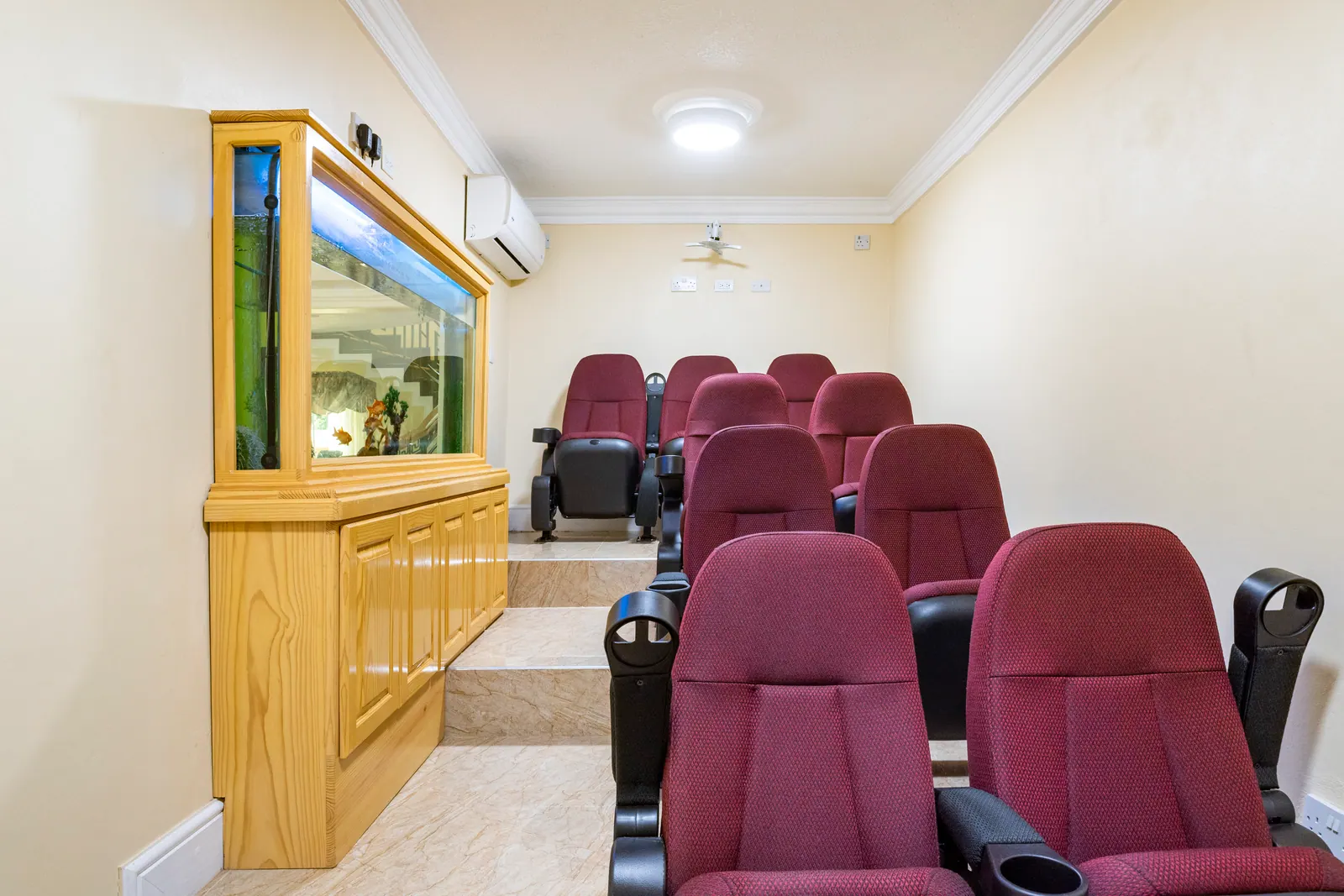 Private cinema room with rows of reclining seats